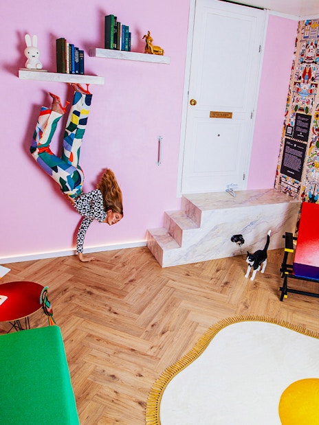 Visitors in Dutch Design Room at Upside Down Amsterdam with colorful decor and unique furniture.