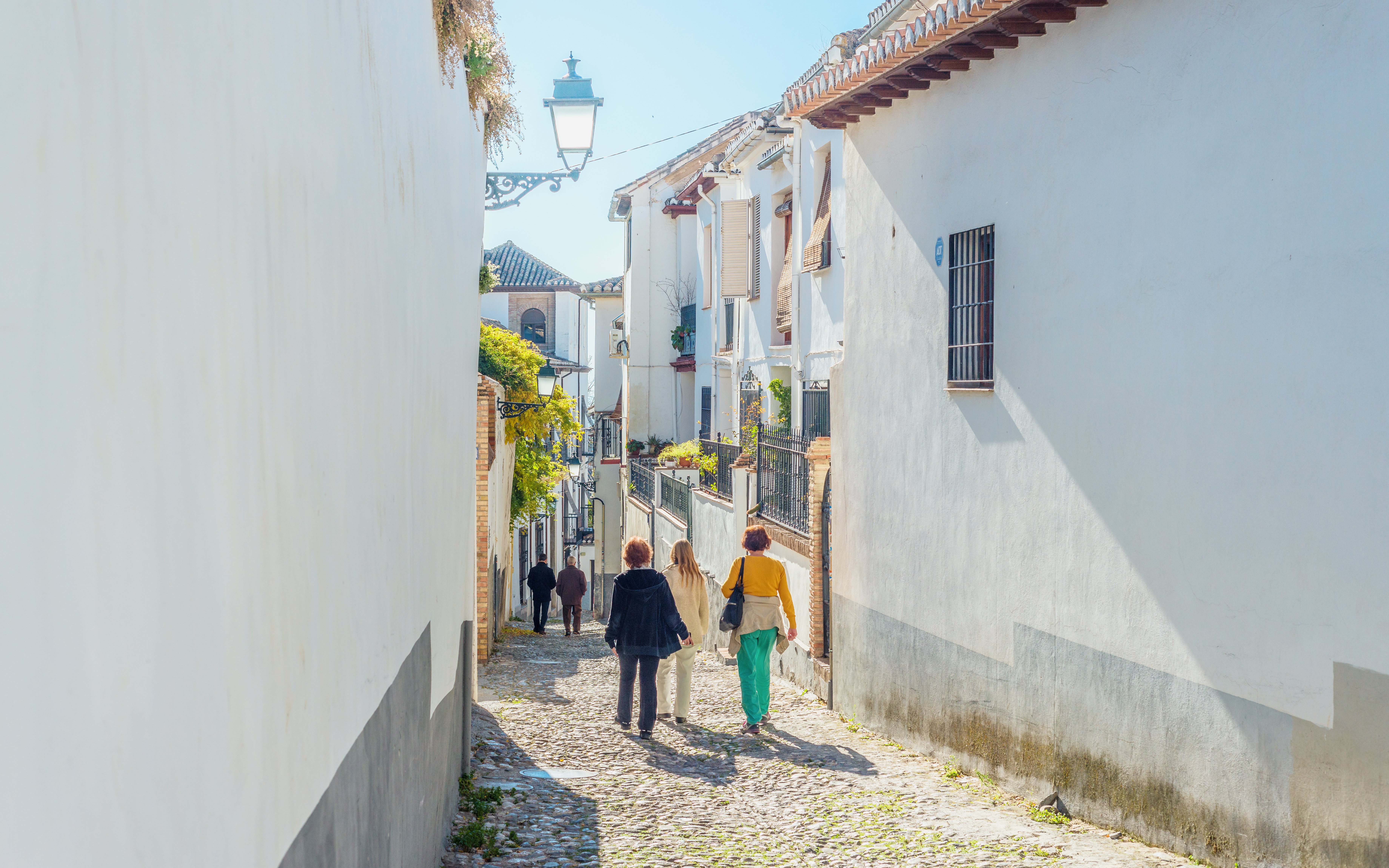 Walking through narrow cobblestone streets in Albaicin de Granada.