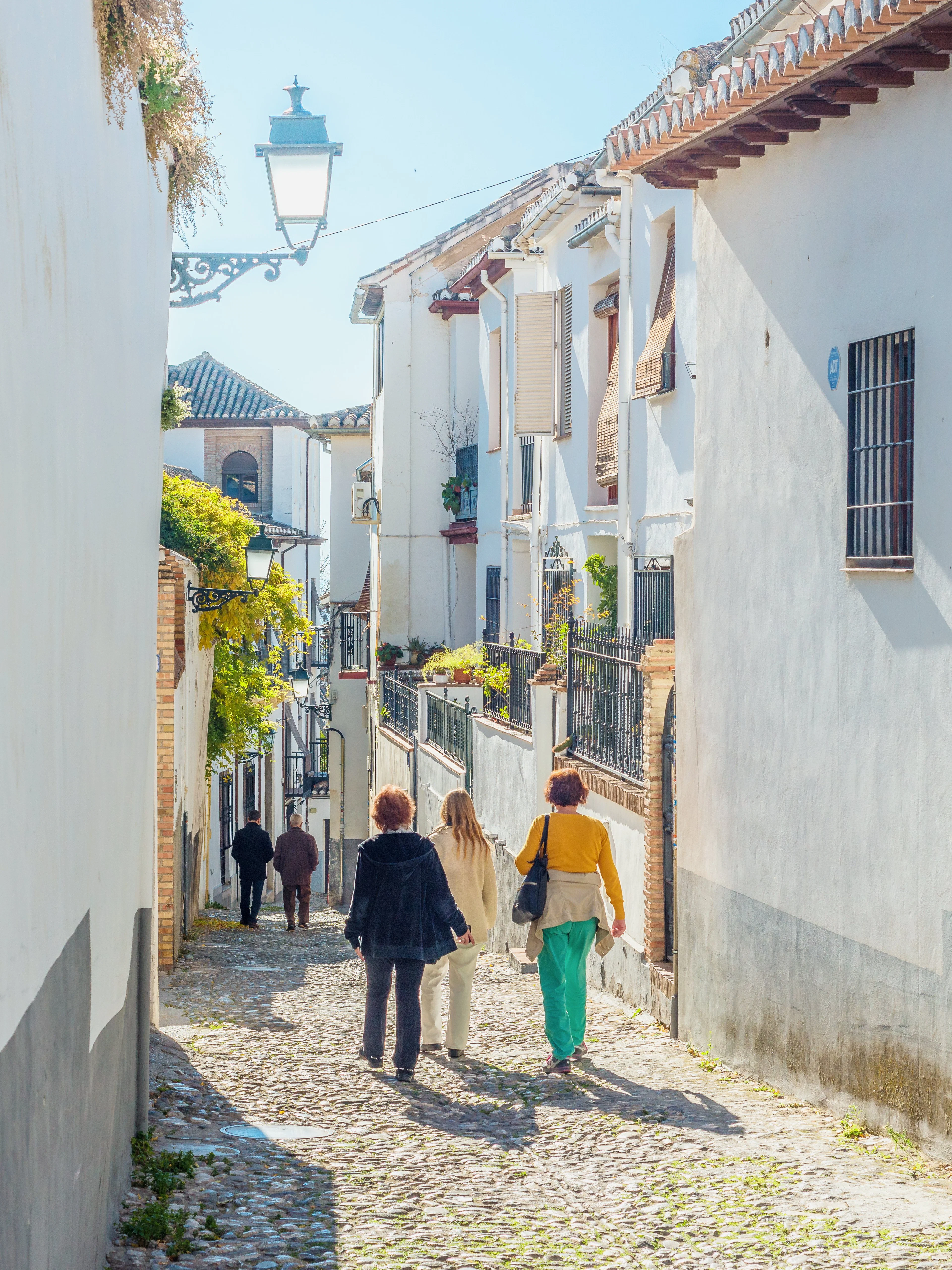 Walking through narrow cobblestone streets in Albaicin de Granada.