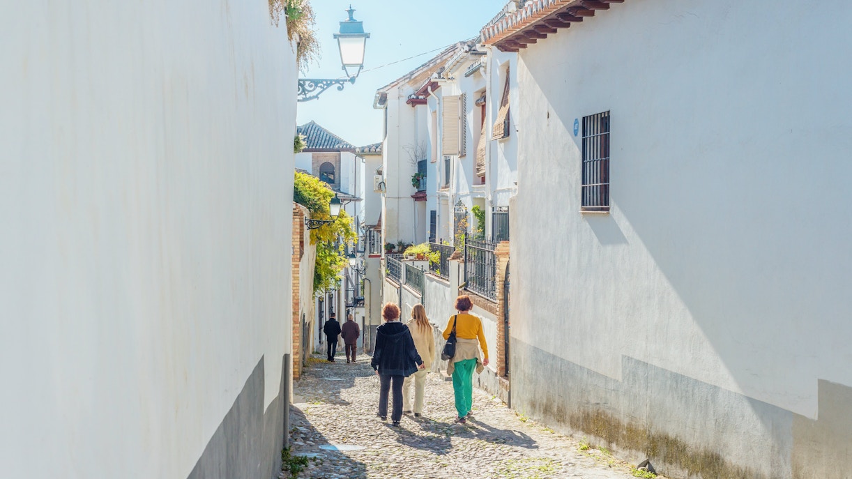 Walking through narrow cobblestone streets in Albaicin de Granada.