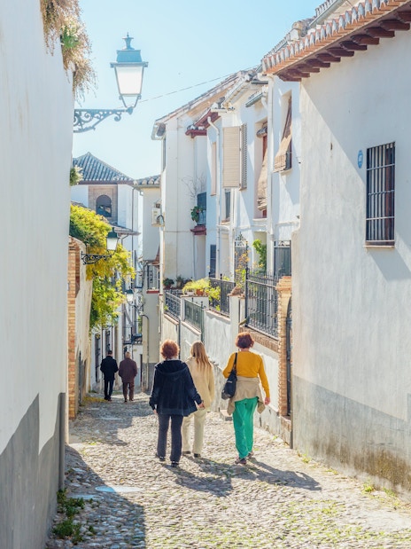 Walking through narrow cobblestone streets in Albaicin de Granada.