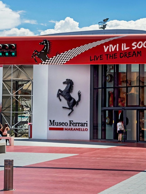 Entrance of the Ferrari Museum in Maranello with iconic prancing horse logo.