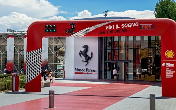 Entrance of the Ferrari Museum in Maranello with iconic prancing horse logo.
