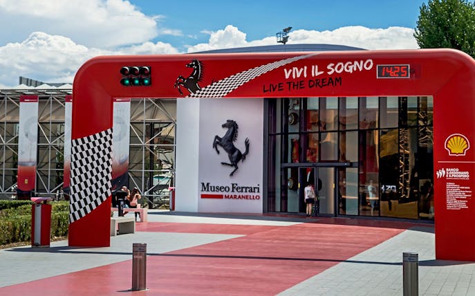 Entrance of the Ferrari Museum in Maranello with iconic prancing horse logo.
