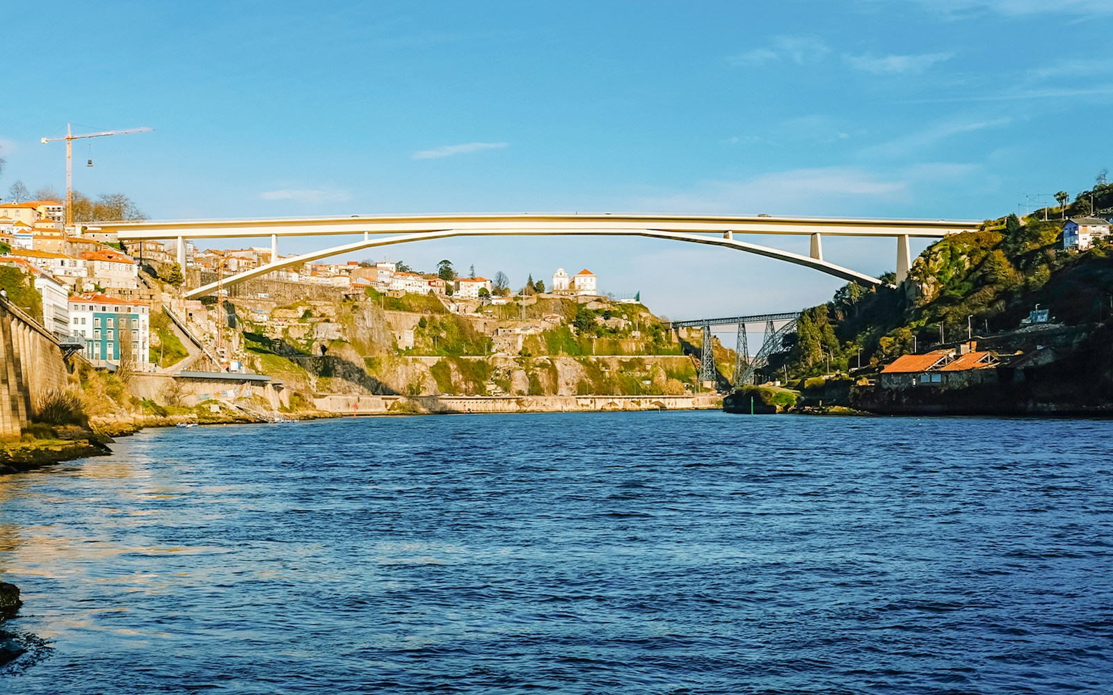 Infante Modern Bridge spanning Douro River in Porto, Portugal with hillside view.