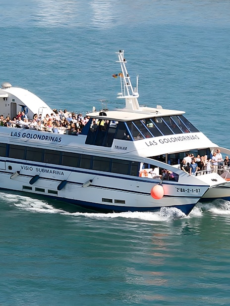 Tourists on a Las Golondrinas boat tour in Barcelona, part of Turbopass attractions.