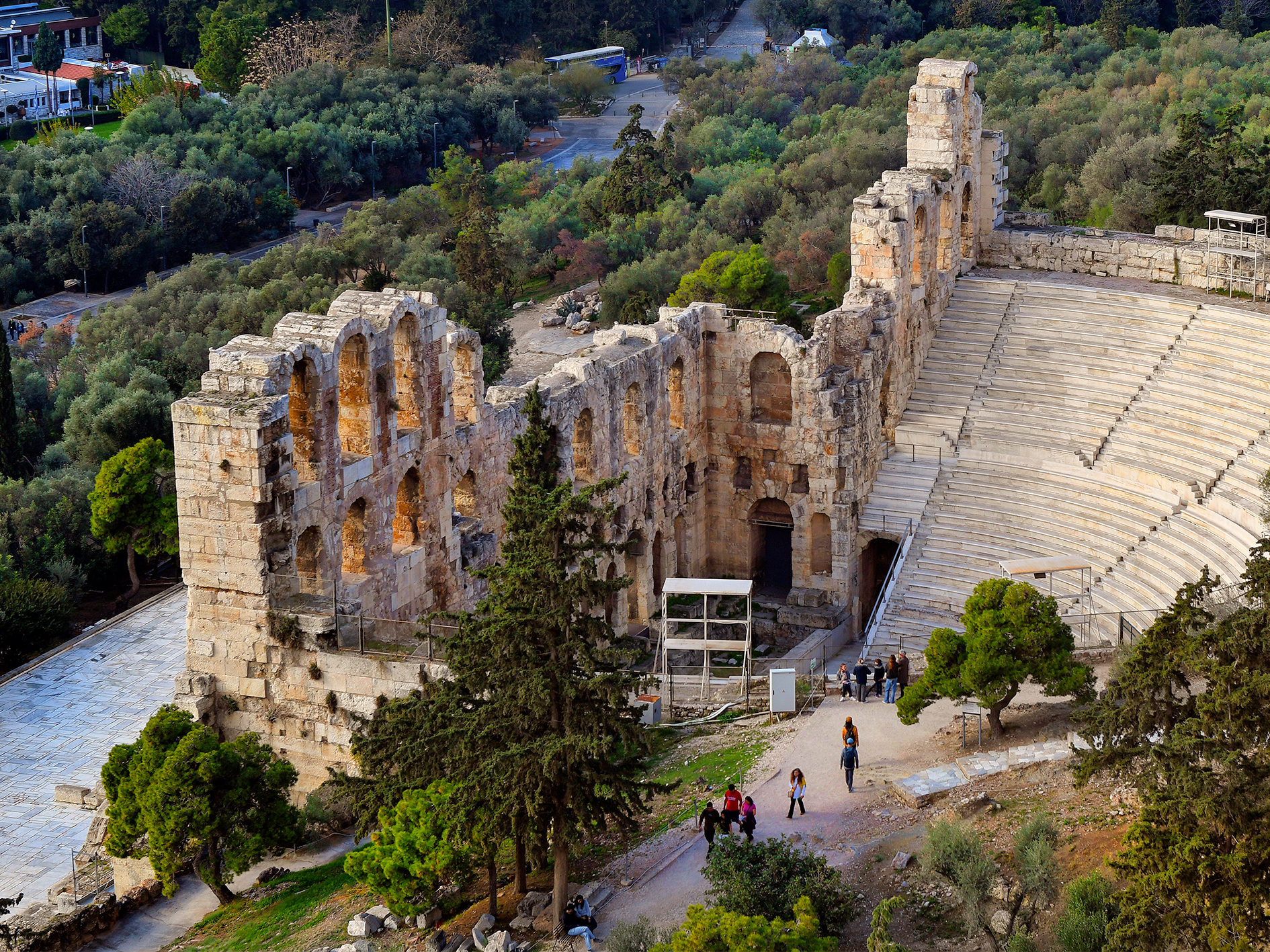 Three story stone facade structure behind the seating area, in ancient Odeon, Greece.