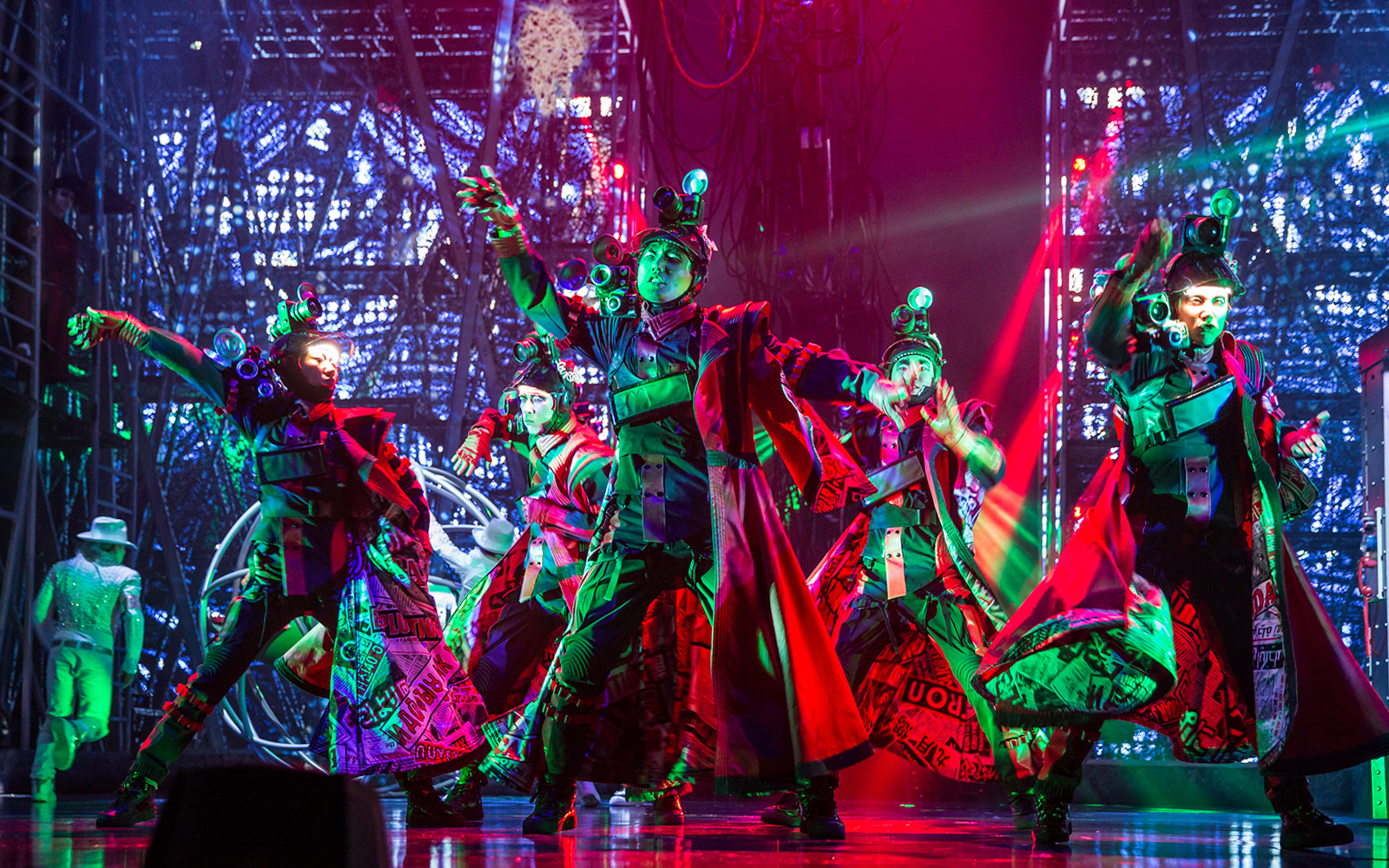 Performers in vibrant costumes dance energetically on stage at Michael Jackson ONE show.