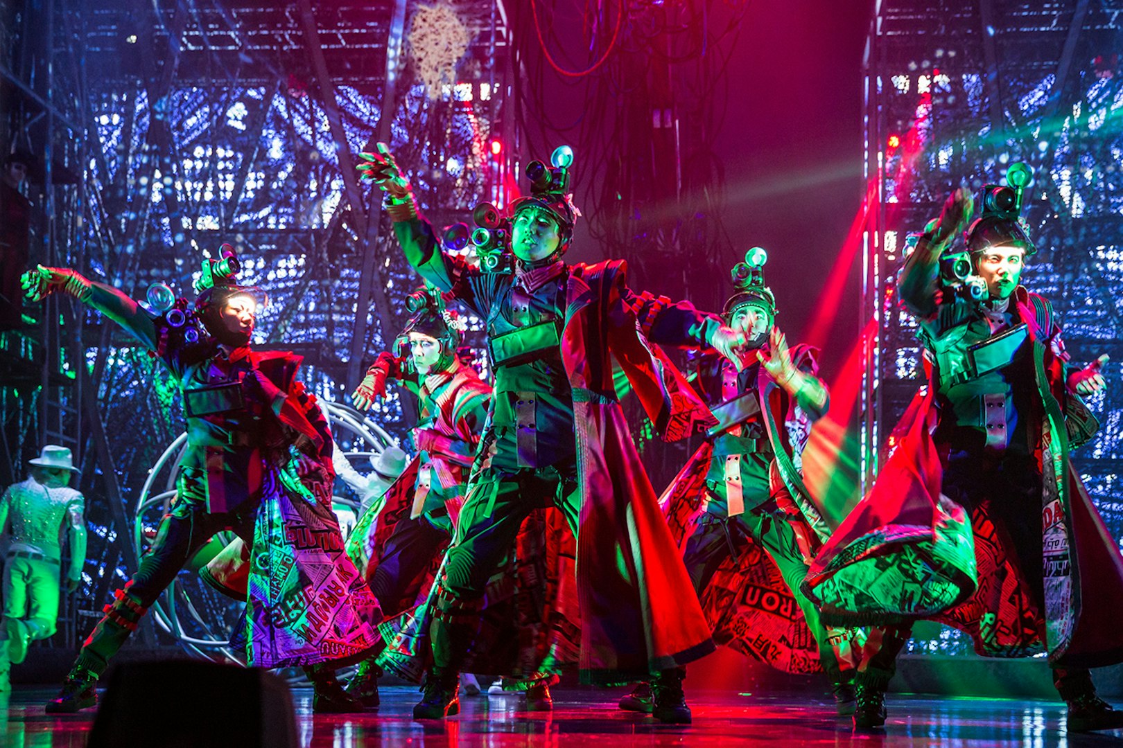Performers in vibrant costumes dance energetically on stage at Michael Jackson ONE show.