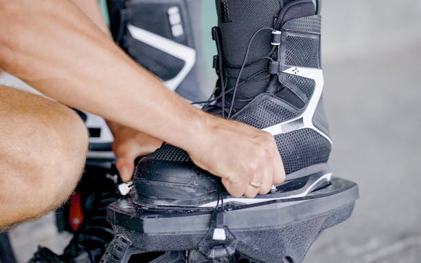 Man securing flyboarding boots for adventure in Dubai.