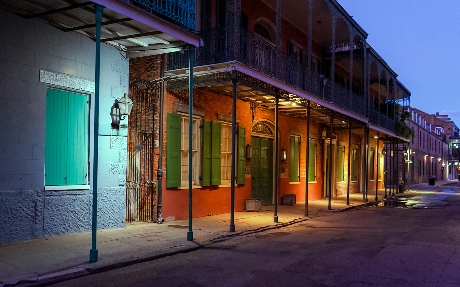 Historic French Quarter street in New Orleans, Louisiana, illuminated at night.