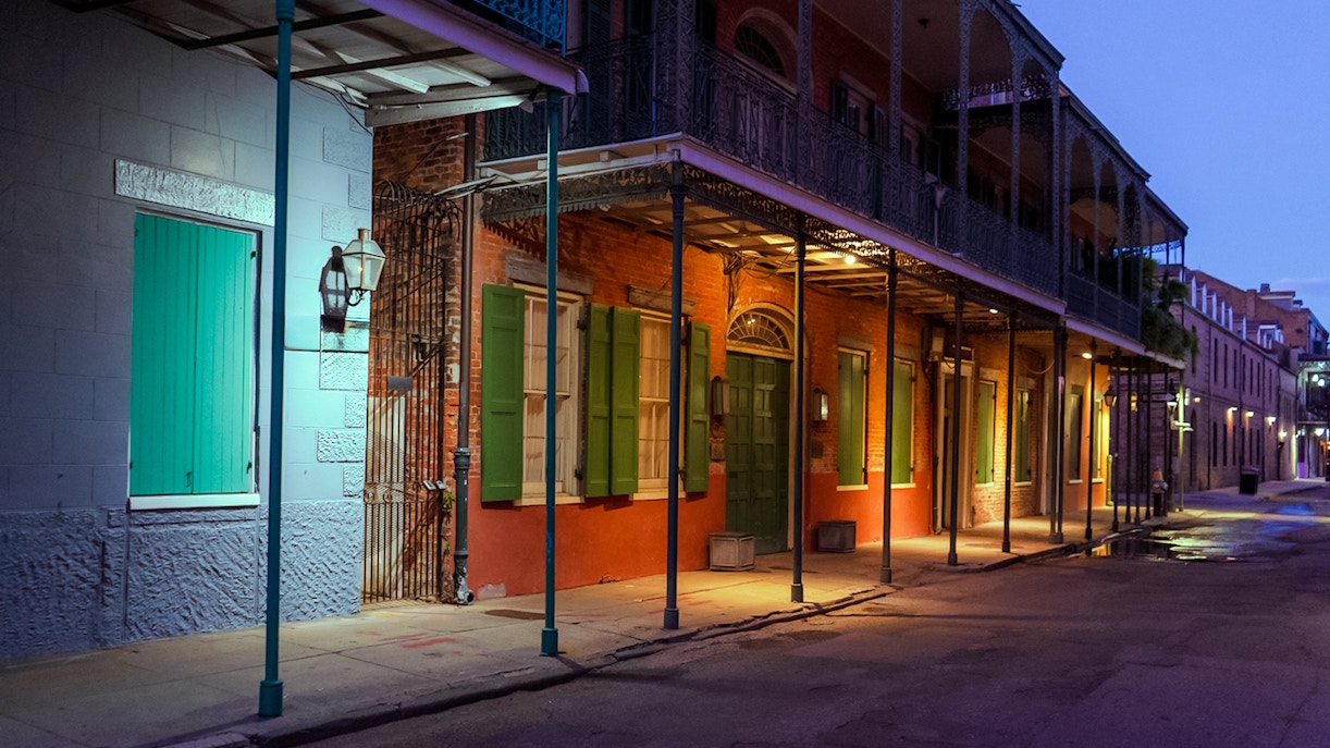 Historic French Quarter street in New Orleans, Louisiana, illuminated at night.