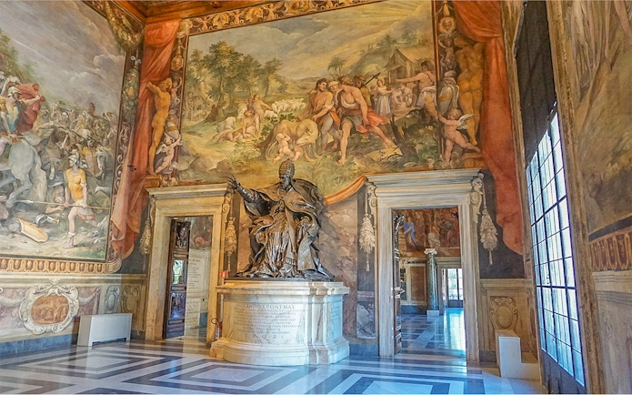 Capitoline Museums interior with statue and frescoes during guided tour in Rome.