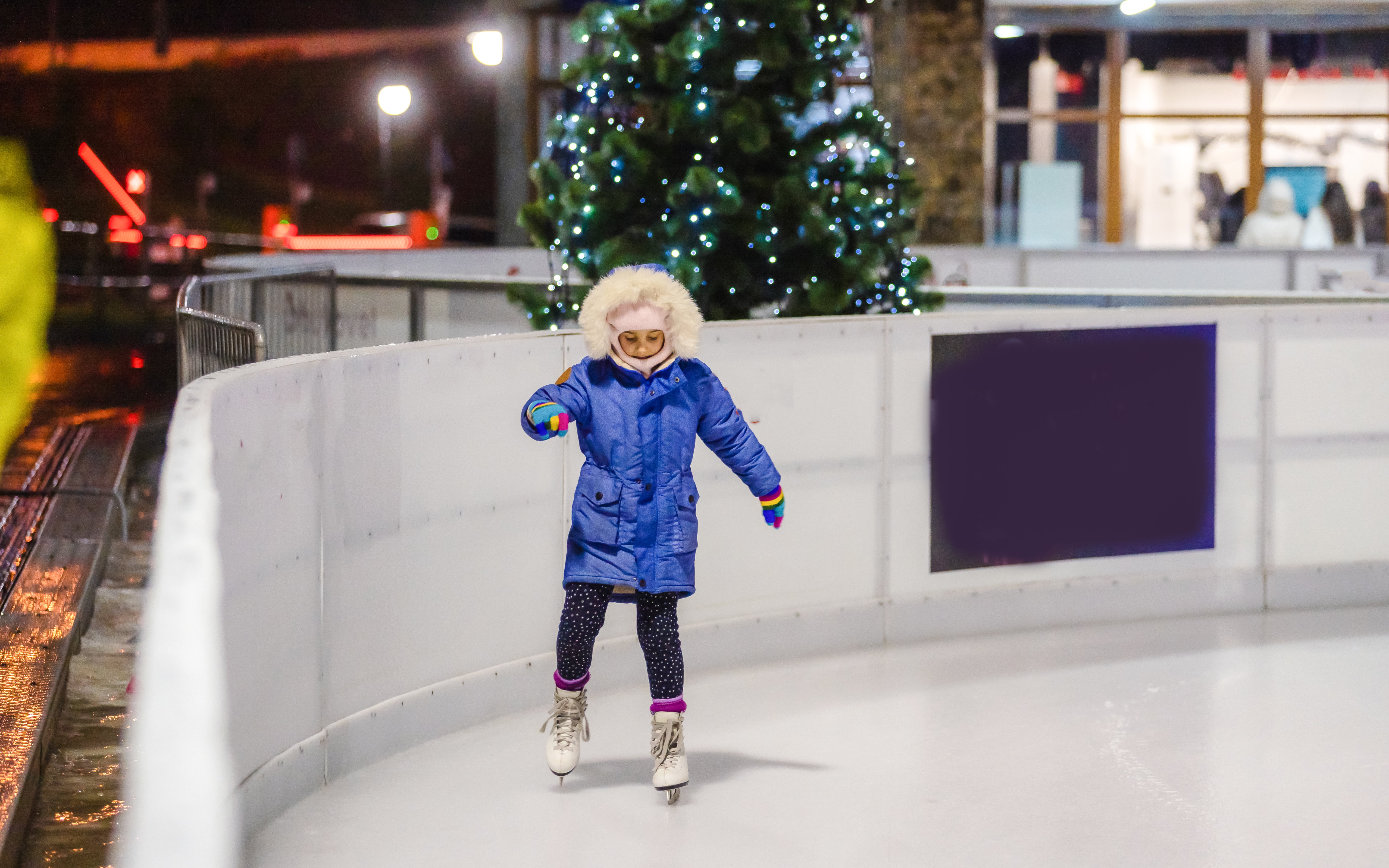 Child ice skating at the Natural History Museum rink in London.