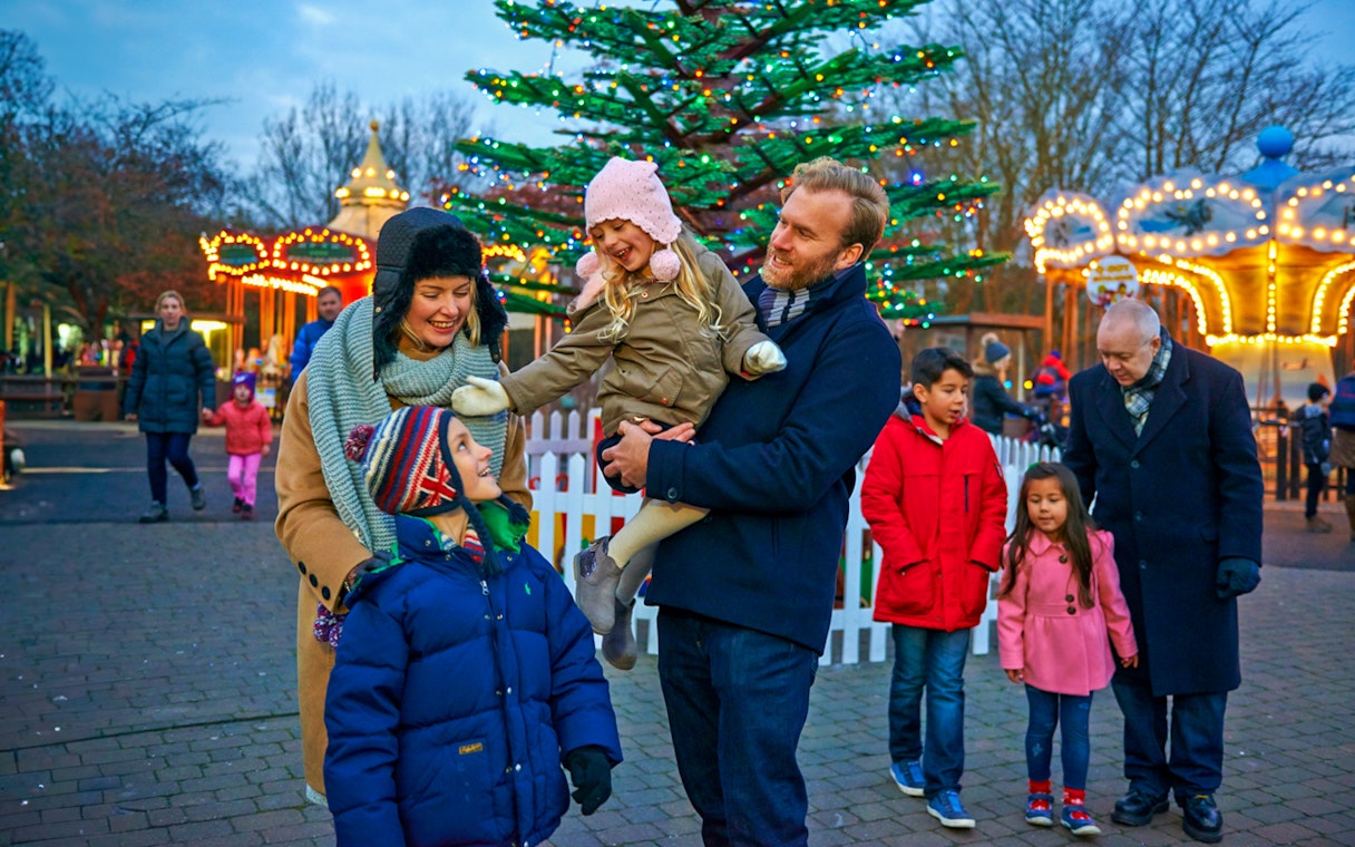 Family enjoying Christmas at Legoland London with festive lights and decorations.