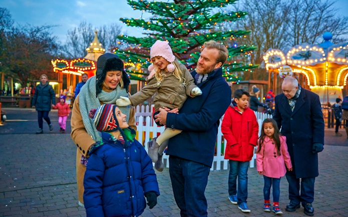Family enjoying Christmas at Legoland London with festive lights and decorations.