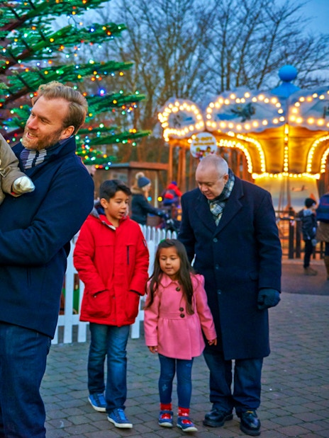 Family enjoying Christmas at Legoland London with festive lights and decorations.