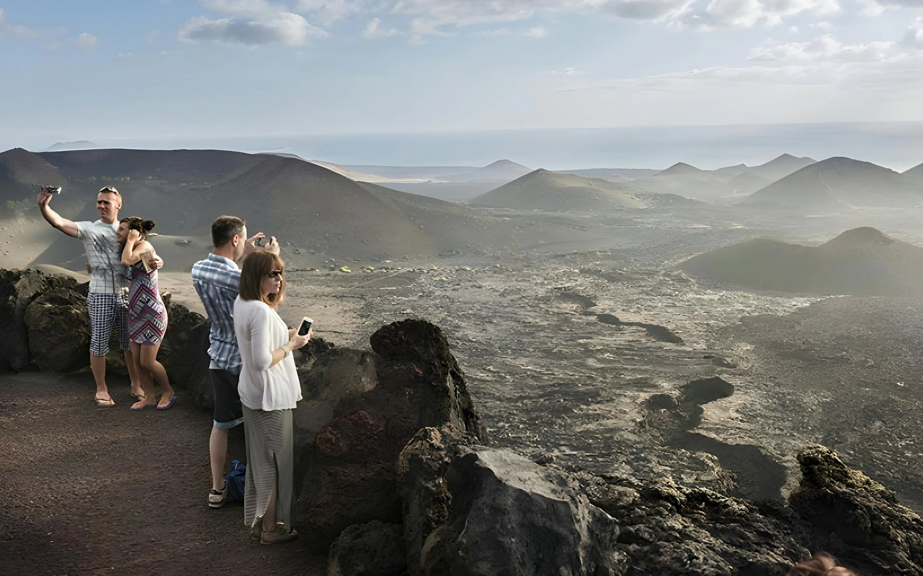 Tourists taking photos at Timanfaya National Park viewpoint, Lanzarote.