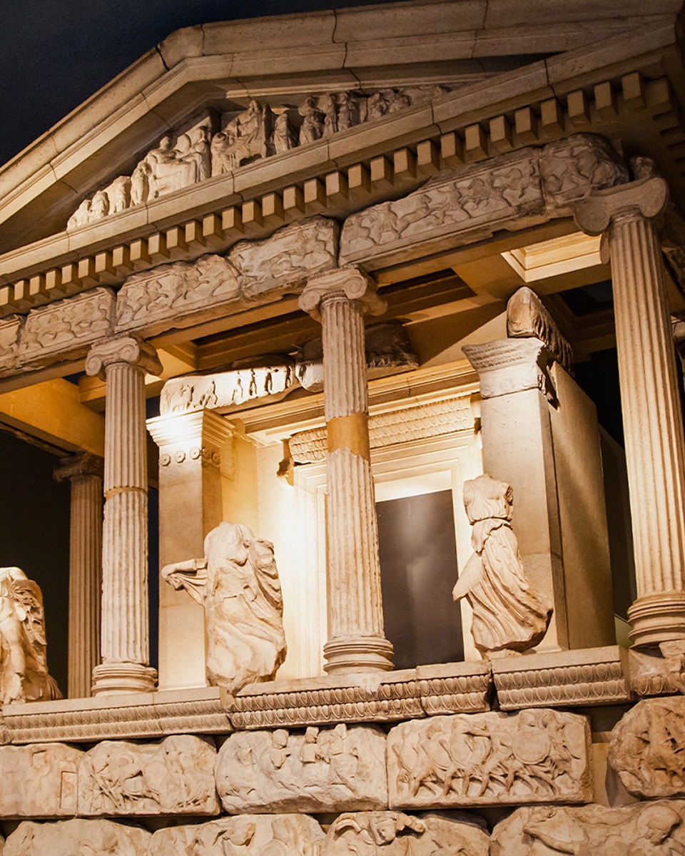 Ancient Greek temple facade at the British Museum with sculptures and columns.