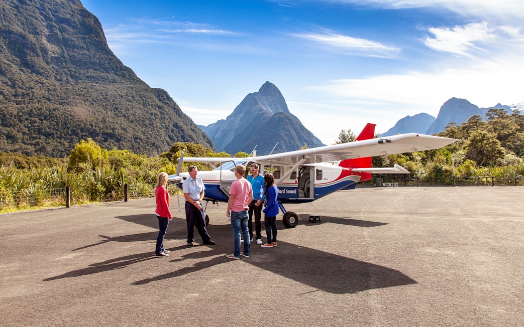 People preparing to board a small plane for a scenic flight to Milford Sound, New Zealand.