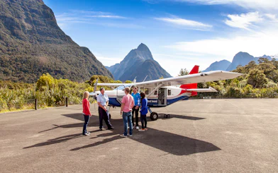 People preparing to board a small plane for a scenic flight to Milford Sound, New Zealand.