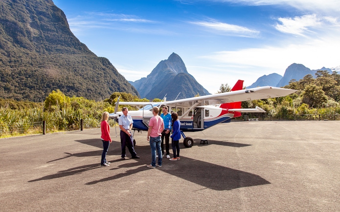 People preparing to board a small plane for a scenic flight to Milford Sound, New Zealand.