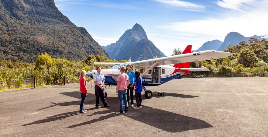 People preparing to board a small plane for a scenic flight to Milford Sound, New Zealand.