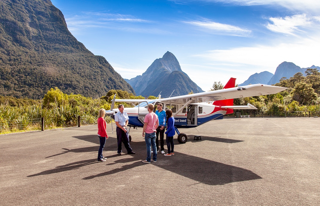 People preparing to board a small plane for a scenic flight to Milford Sound, New Zealand.