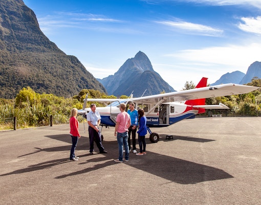 People preparing to board a small plane for a scenic flight to Milford Sound, New Zealand.