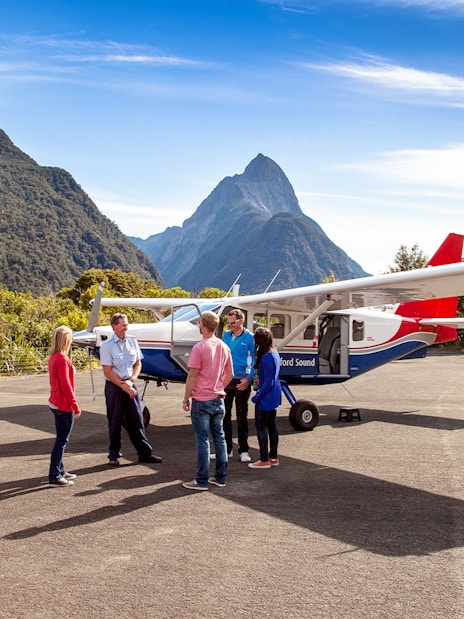 People preparing to board a small plane for a scenic flight to Milford Sound, New Zealand.