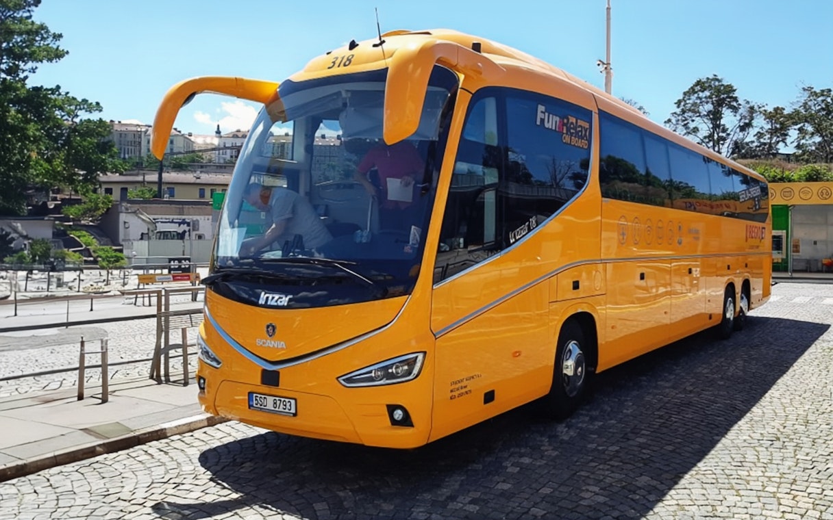 Yellow airport shuttle bus for Prague city center transfer.