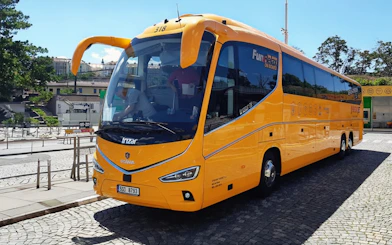 Yellow airport shuttle bus for Prague city center transfer.