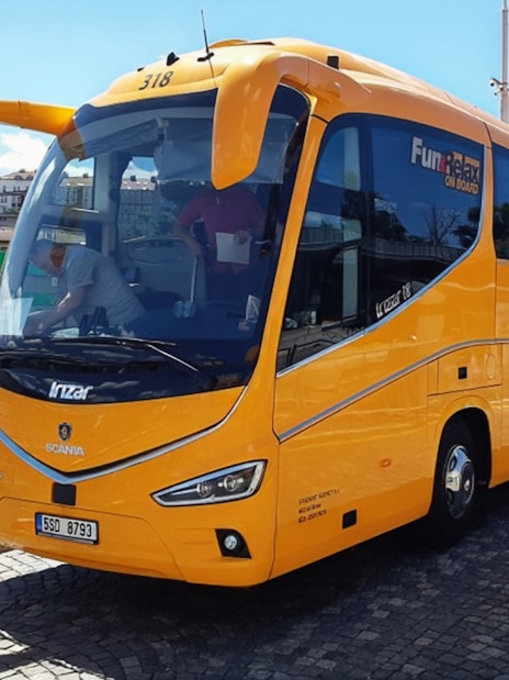Yellow airport shuttle bus for Prague city center transfer.