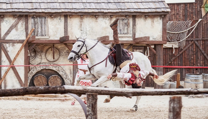 Puy du Fou España performers in historical costumes during an outdoor show.