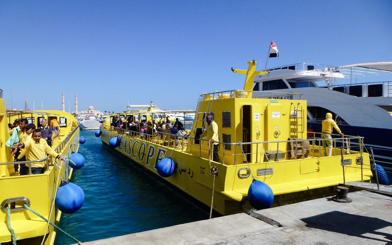Yellow Royal Seascope submarines docked at a marina, preparing for a cruise with snorkel stop.