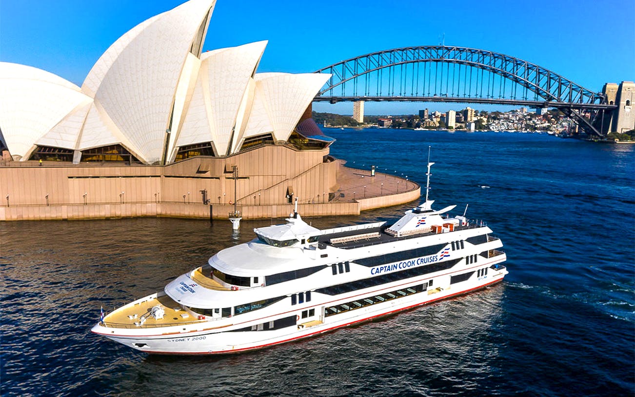 Sydney Harbour view with Captain Cook cruise, Opera House, and Harbour Bridge.