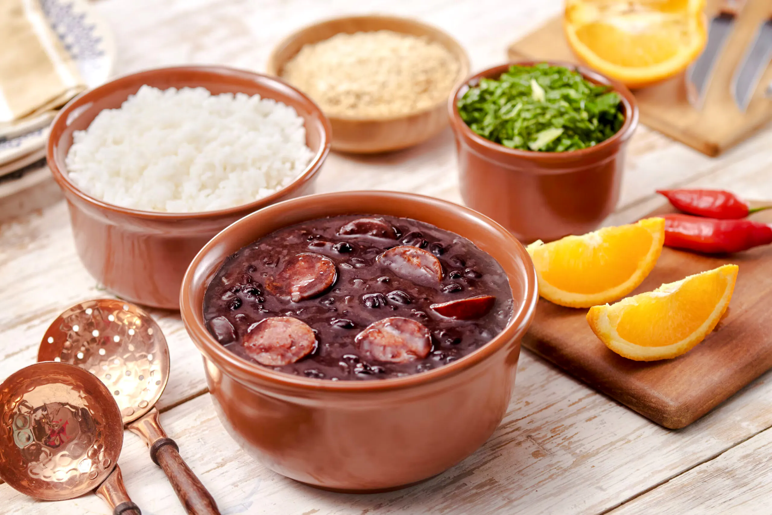 Feijoada with rice, greens, and orange slices in Rio de Janeiro tour.