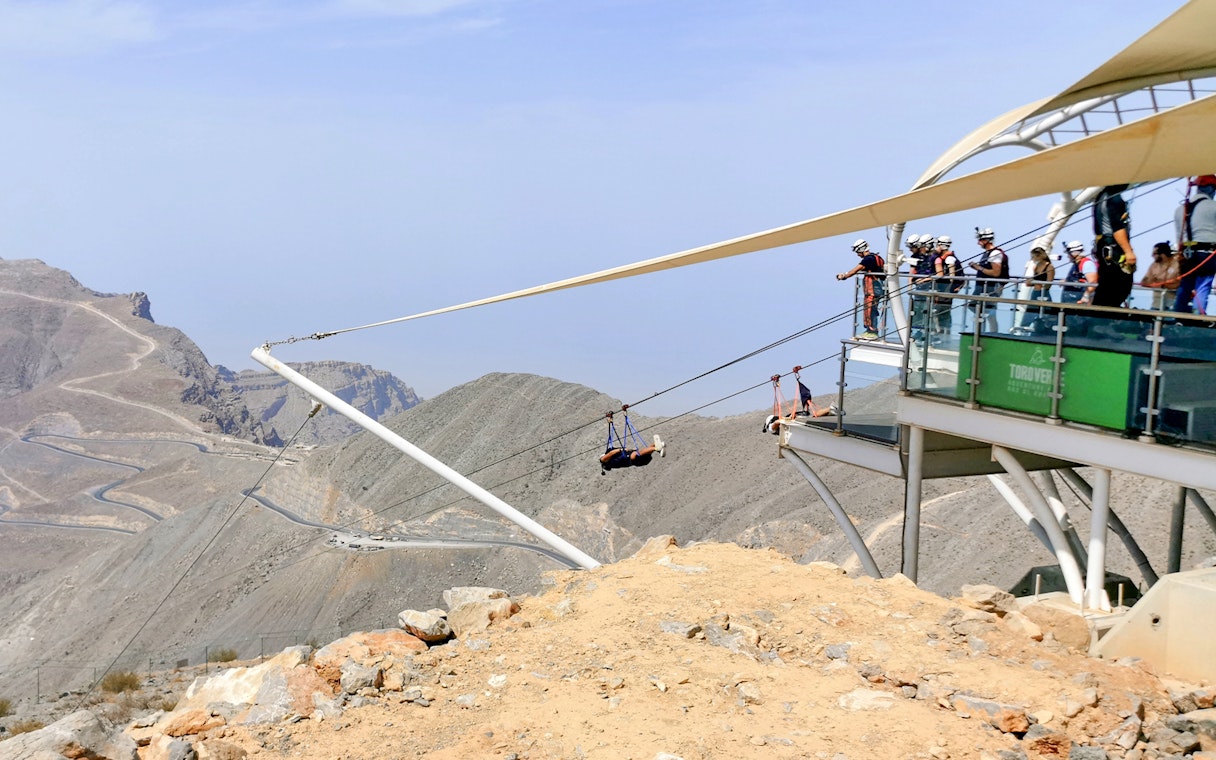 Zipline launch at Jebel Jais, Ras Al Khaimah, with mountainous landscape in view.