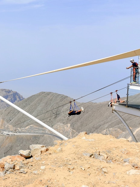 Zipline launch at Jebel Jais, Ras Al Khaimah, with mountainous landscape in view.