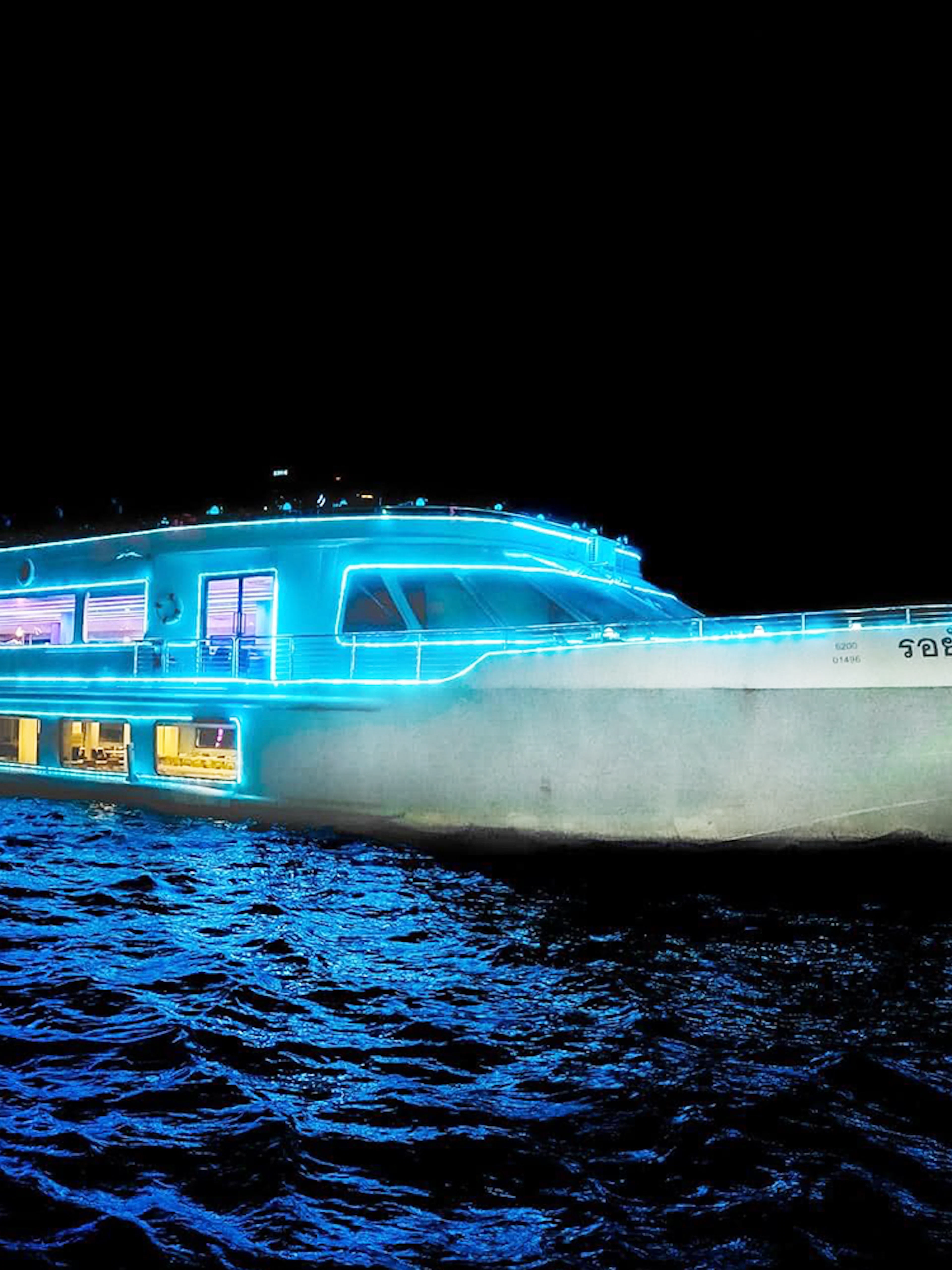 Royal Princess Cruise ship illuminated at night on the Chao Phraya River in Bangkok.