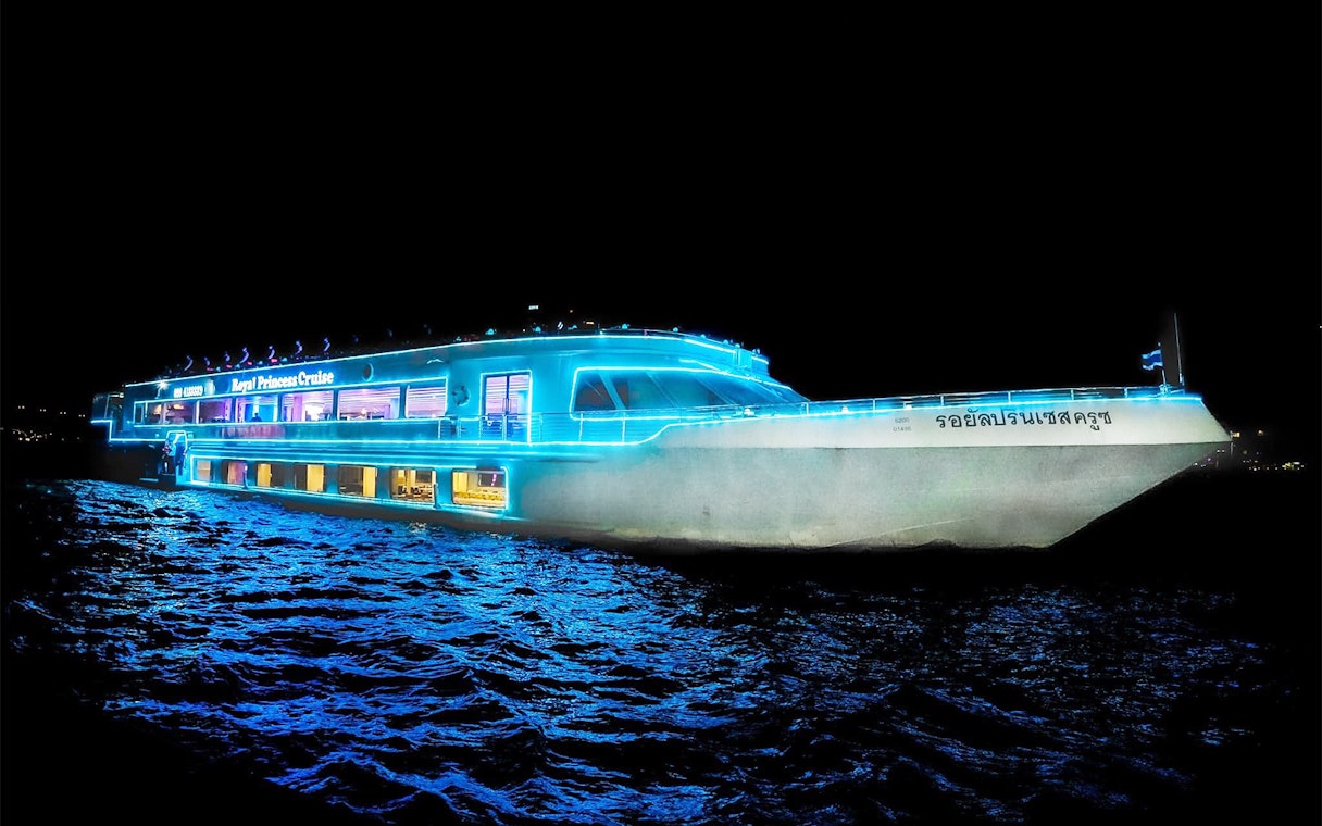 Royal Princess Cruise ship illuminated at night on the Chao Phraya River in Bangkok.