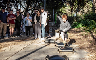 Group watching a child play during a guided walking tour of Montjuïc.
