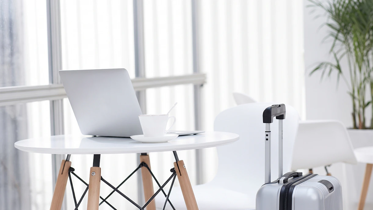 Laptop and coffee cup on table in Skyserv Aristotle Onassis Lounge, Athens International Airport.