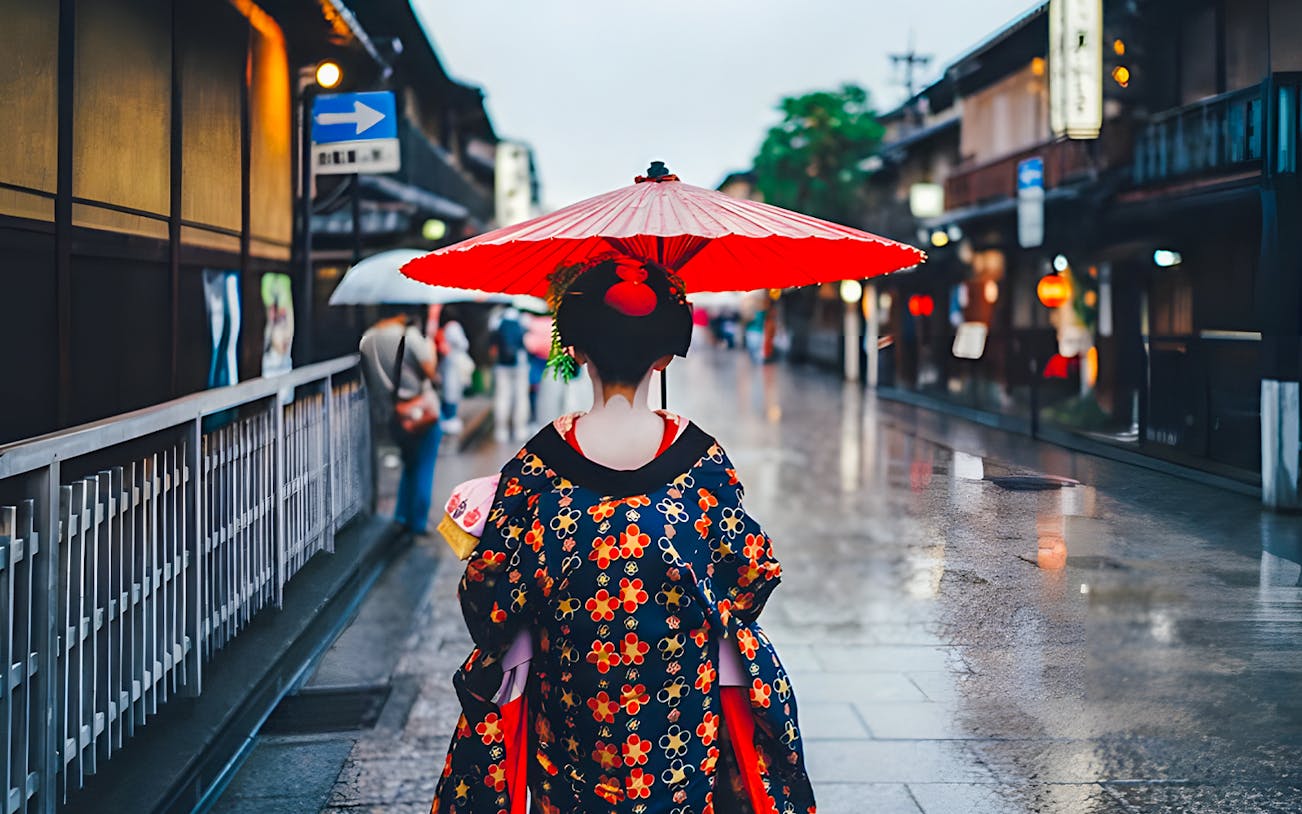 Geisha walking with red umbrella in Kyoto's historic district.