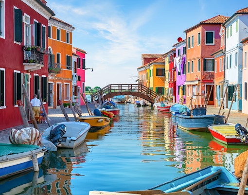 Tre Ponti Bridge in Burano, Italy, with colorful houses lining the canal.
