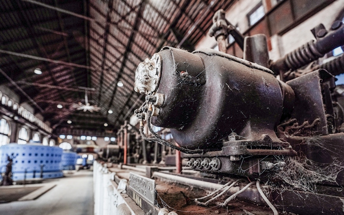 Niagara Power Station interior with vintage machinery and large blue generators.