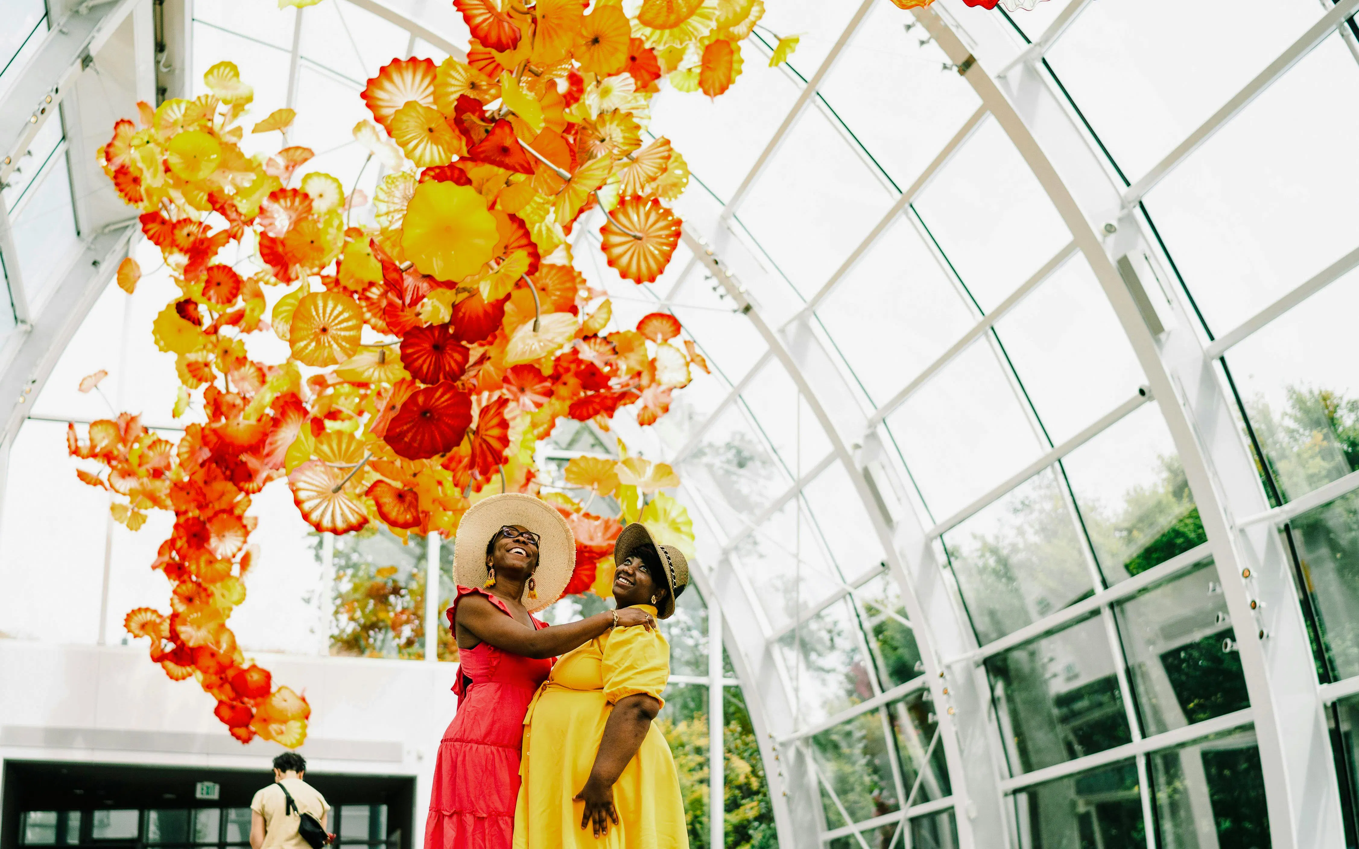 Visitors enjoying colorful glass sculptures at Chihuly Garden and Glass, Seattle.