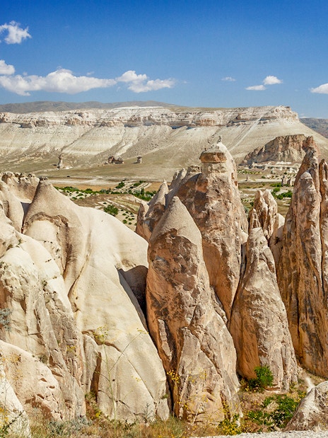 Cappadocia rock formations under blue sky during private jeep safari tour.