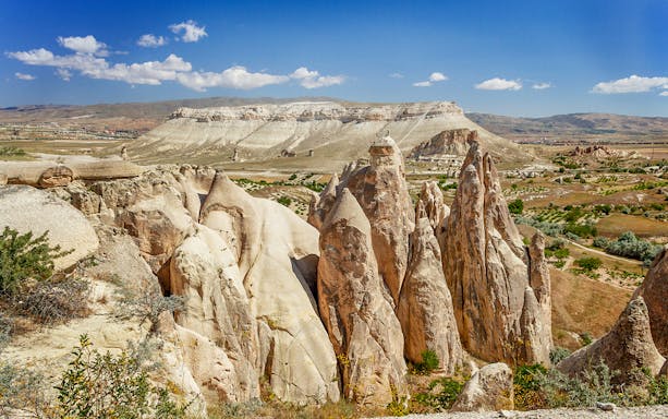 Cappadocia rock formations under blue sky during private jeep safari tour.