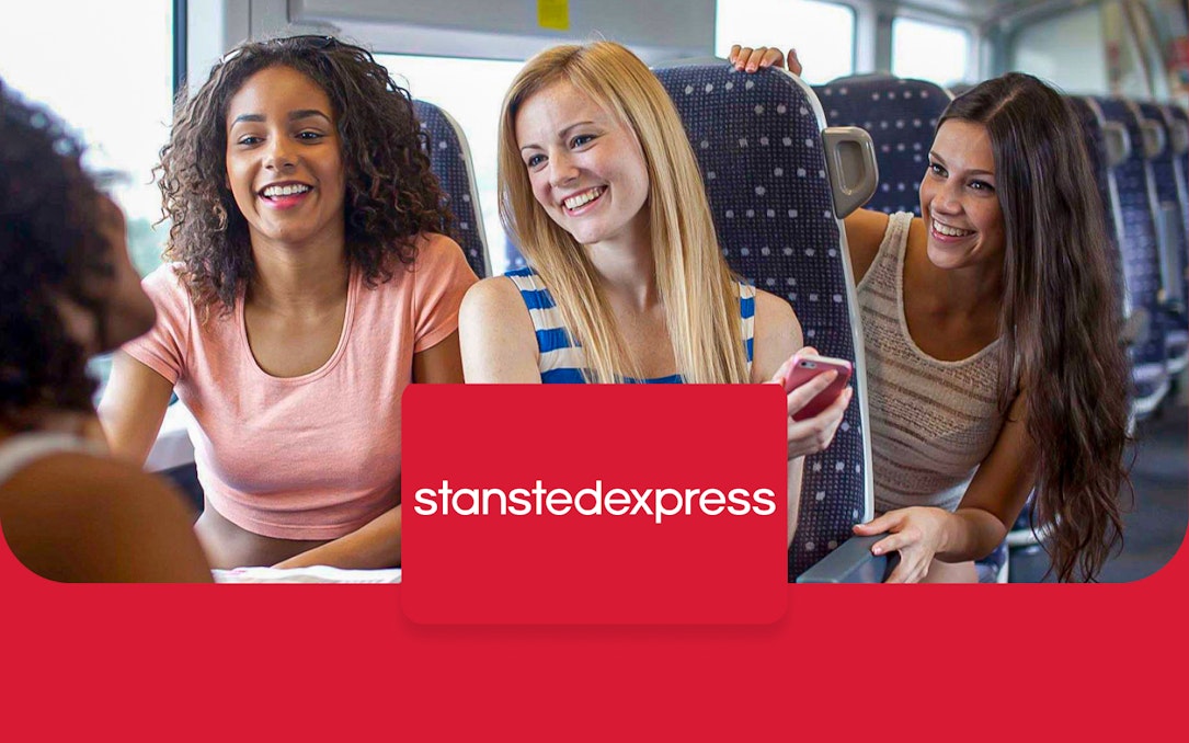 Passengers enjoying a train ride on the Stansted Express from London Stansted Airport to Liverpool Street.